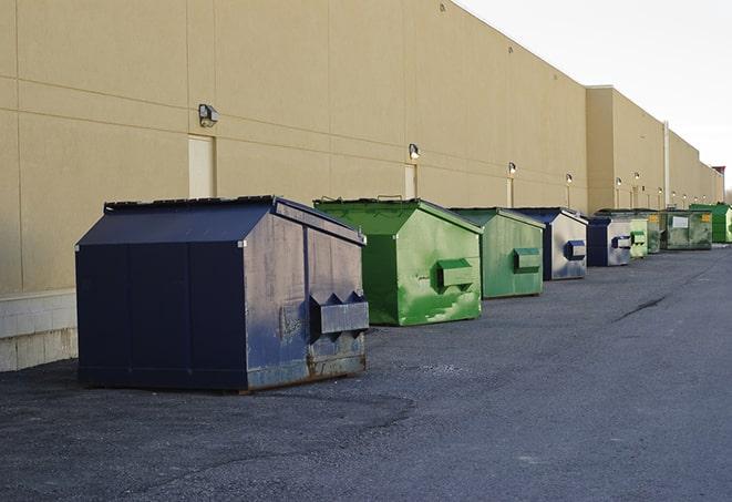 construction workers toss wood scraps into a dumpster in Cibolo TX